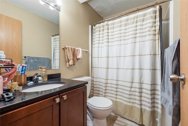 bathroom featuring vanity, a textured ceiling, and toilet