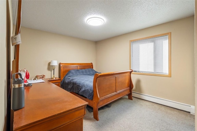 bedroom with a textured ceiling and baseboard heating