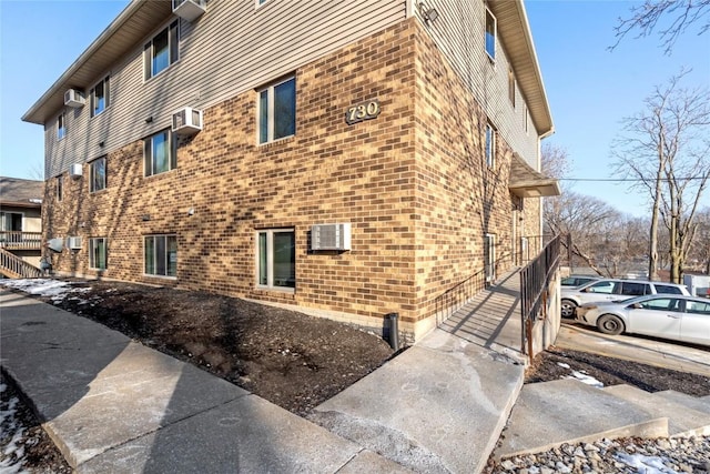 view of building exterior with a wall mounted AC