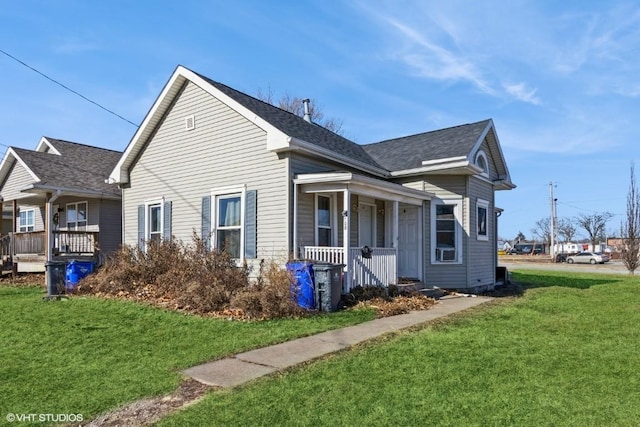 view of home's exterior featuring a lawn and covered porch