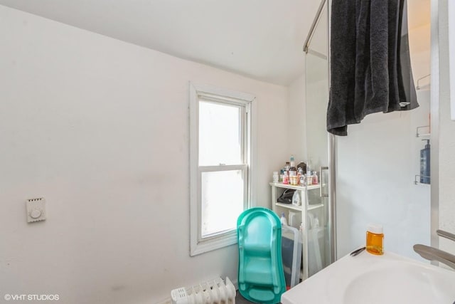 bathroom featuring lofted ceiling