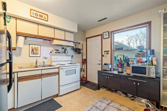 kitchen featuring electric stove, sink, a textured ceiling, and white cabinets