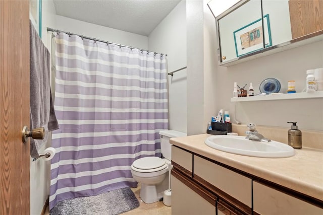 bathroom with vanity, a textured ceiling, and toilet