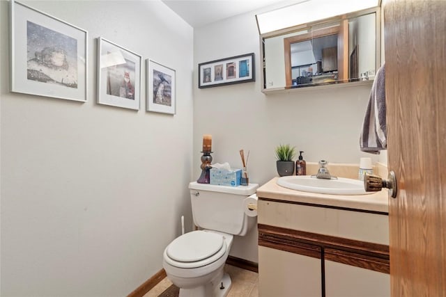 bathroom with vanity, toilet, and tile patterned flooring