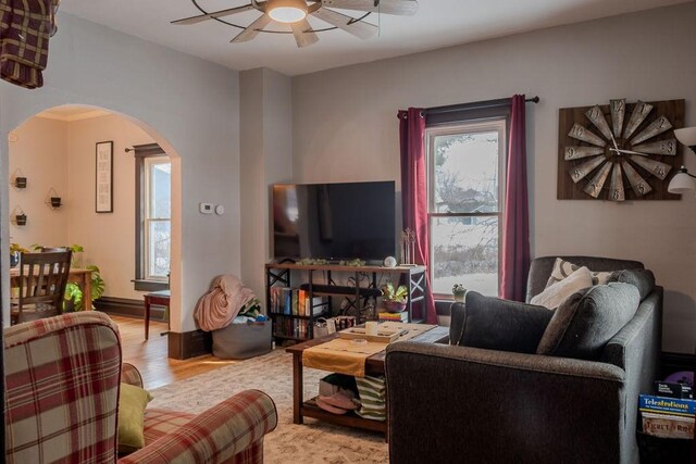 living room with ceiling fan and light hardwood / wood-style floors