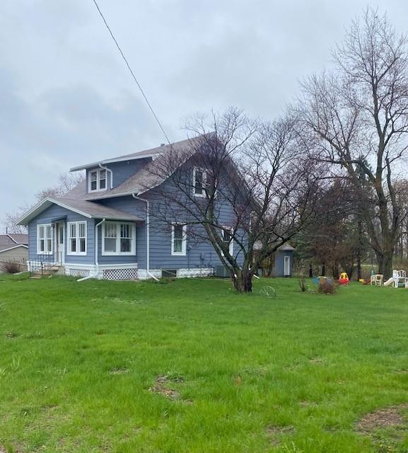 view of home's exterior with a lawn