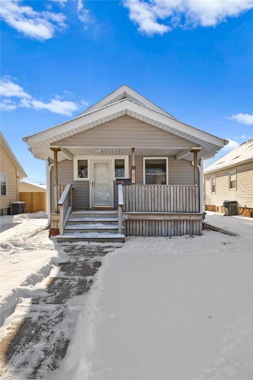 view of front of house featuring cooling unit and covered porch