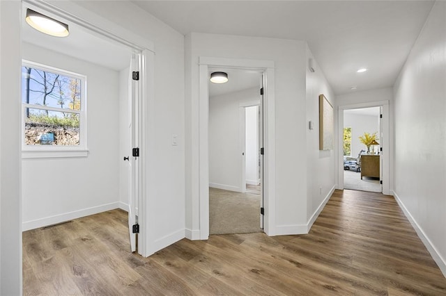 hall with light hardwood / wood-style flooring