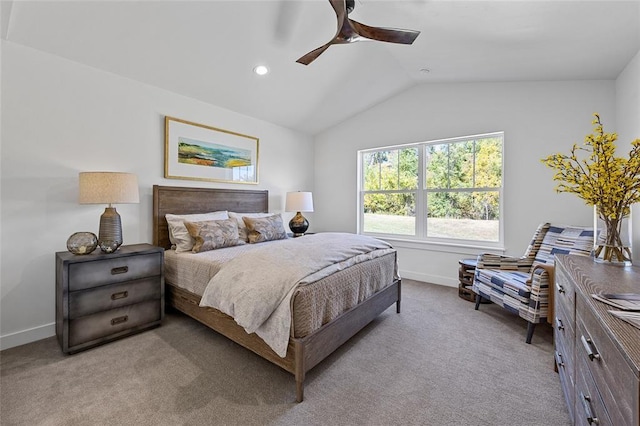 bedroom with ceiling fan, vaulted ceiling, and light carpet