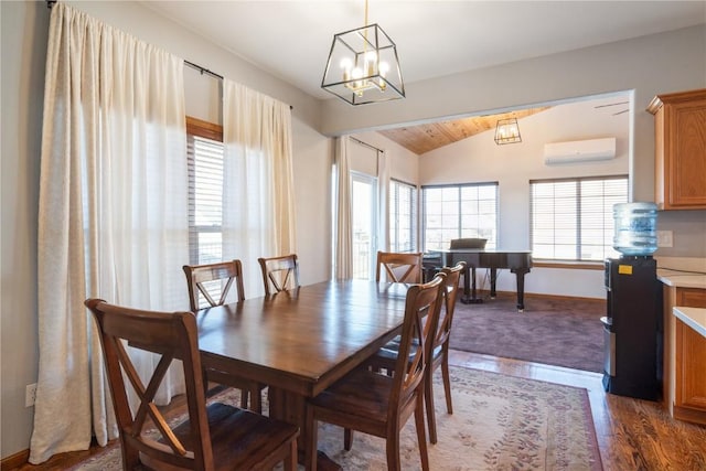 dining space with lofted ceiling, plenty of natural light, dark hardwood / wood-style floors, and a wall mounted AC