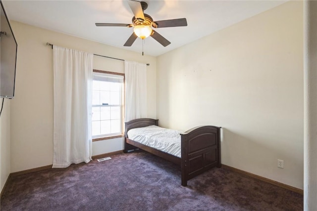 bedroom featuring dark colored carpet and ceiling fan