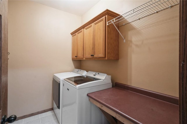 laundry area with cabinets and washing machine and clothes dryer