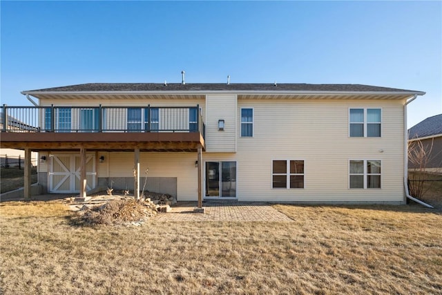 back of house with a wooden deck and a lawn