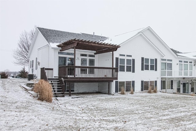 snow covered property featuring a wooden deck and a pergola