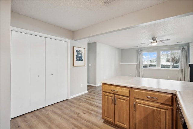 kitchen with ceiling fan, light hardwood / wood-style floors, and a textured ceiling