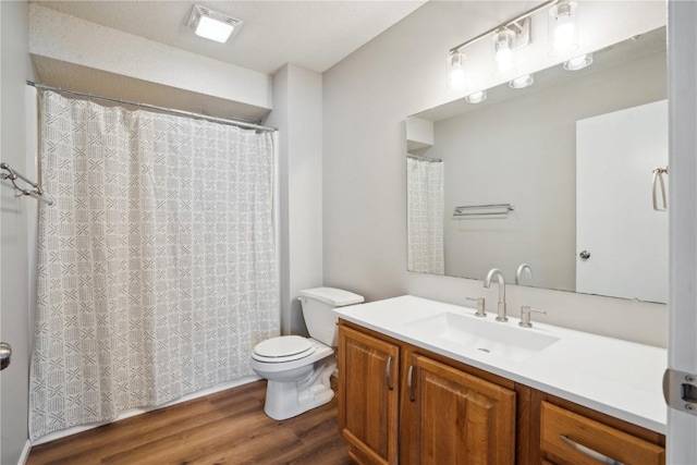 bathroom with vanity, wood-type flooring, and toilet