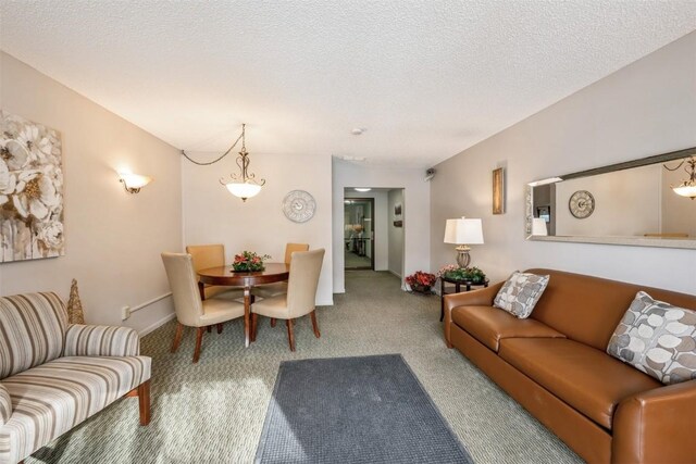 living room with a textured ceiling and carpet