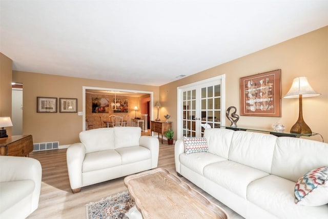 living room with french doors and hardwood / wood-style floors