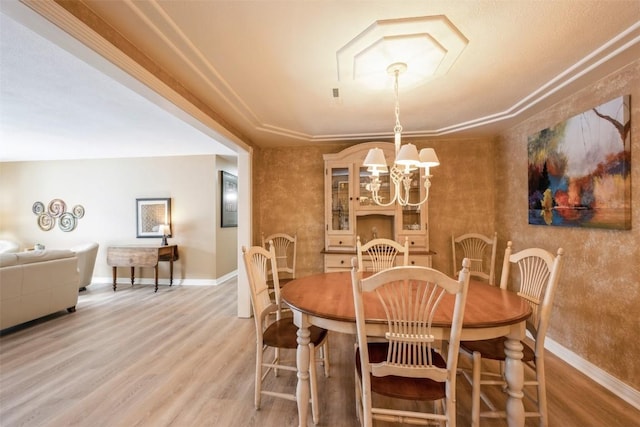 dining area featuring wood-type flooring and a chandelier