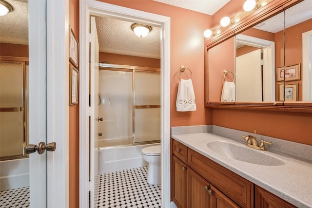 full bathroom featuring vanity, toilet, enclosed tub / shower combo, and a textured ceiling