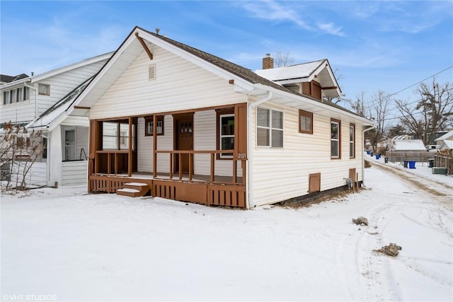 bungalow featuring cooling unit and a porch