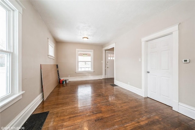 spare room featuring dark wood-type flooring