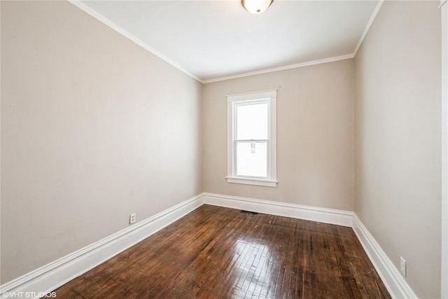 spare room featuring hardwood / wood-style flooring and crown molding