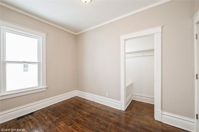 unfurnished bedroom featuring multiple windows, ornamental molding, dark hardwood / wood-style floors, and a closet