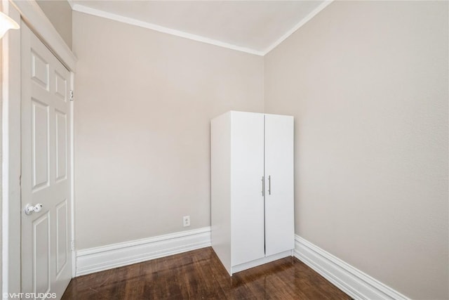 unfurnished bedroom with ornamental molding and dark hardwood / wood-style flooring