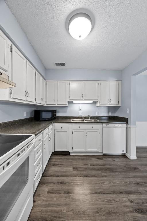 kitchen with white cabinetry, white appliances, and dark wood-type flooring