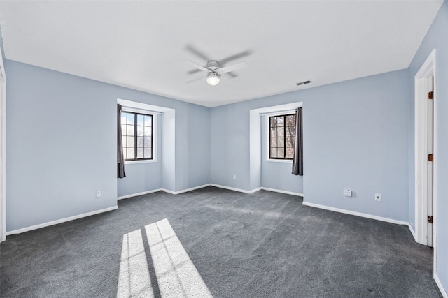 carpeted spare room with ceiling fan