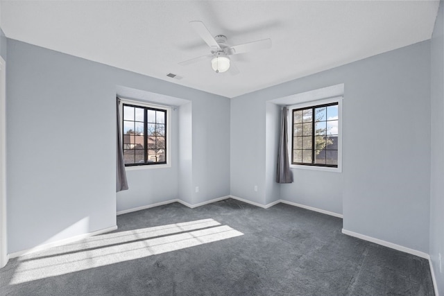 carpeted spare room featuring ceiling fan