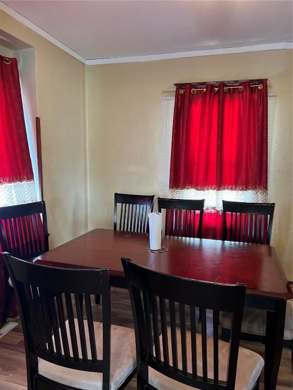 dining area featuring crown molding and wood finished floors