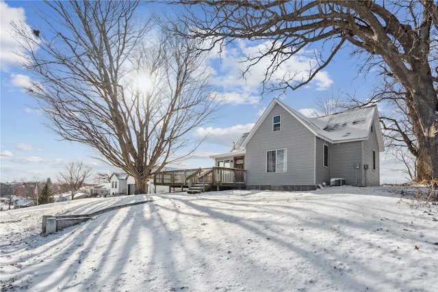 view of snowy exterior featuring central AC unit