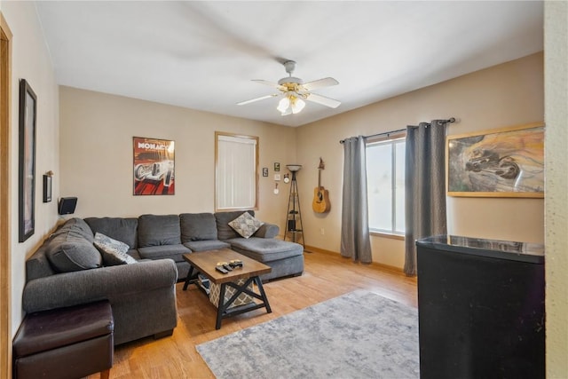 living room featuring light hardwood / wood-style flooring and ceiling fan