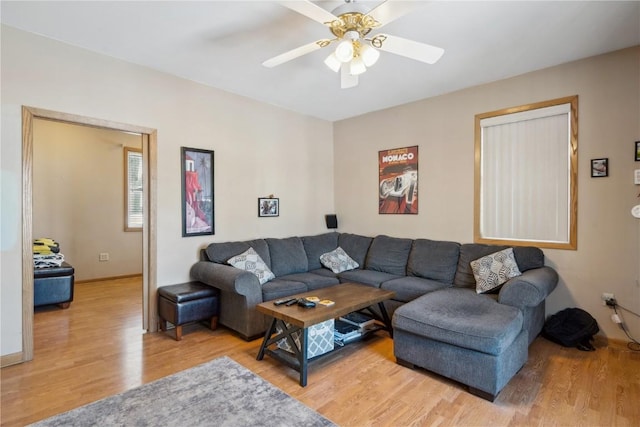 living room featuring wood-type flooring and ceiling fan