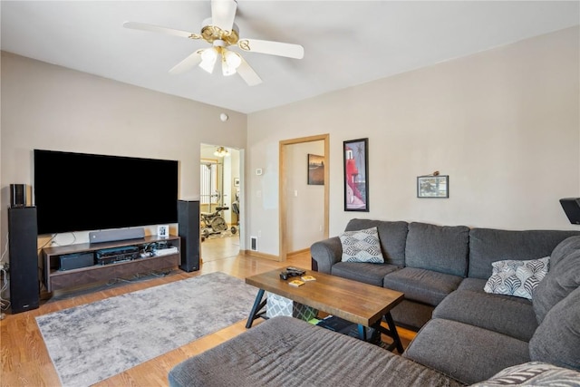 living room with wood-type flooring and ceiling fan