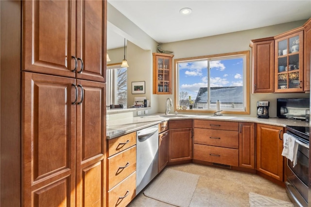 kitchen featuring hanging light fixtures, sink, and appliances with stainless steel finishes