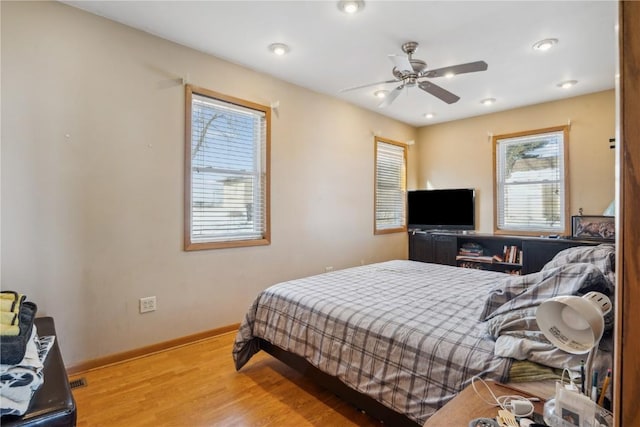 bedroom with ceiling fan and hardwood / wood-style floors