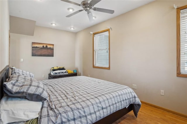 bedroom with ceiling fan and light hardwood / wood-style flooring