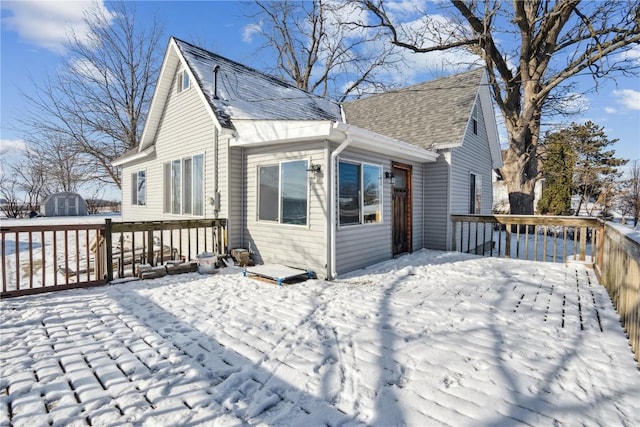 exterior space featuring a deck and a storage shed