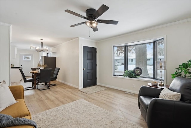 living room with crown molding, ceiling fan with notable chandelier, and light wood-type flooring