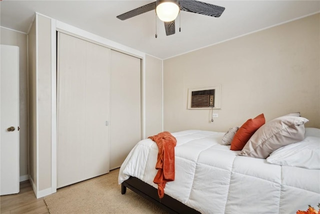 bedroom with ceiling fan and a closet