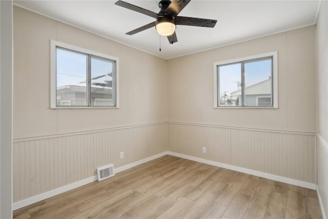 spare room featuring ceiling fan and light hardwood / wood-style flooring