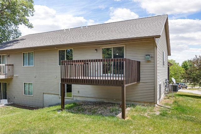 back of house with a yard and central AC