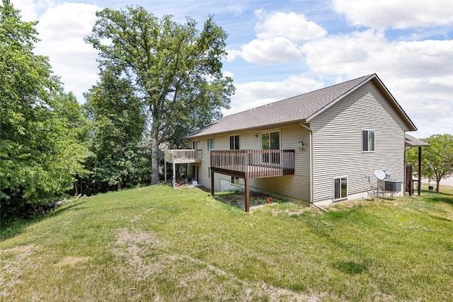 back of property featuring a wooden deck and a yard