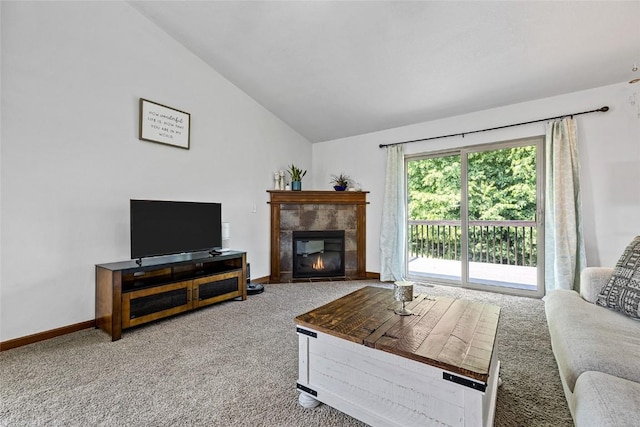 carpeted living room featuring lofted ceiling and a fireplace