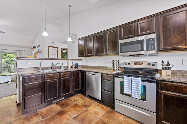 kitchen featuring sink, vaulted ceiling, dark brown cabinets, appliances with stainless steel finishes, and pendant lighting