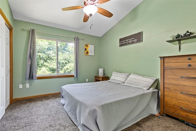 bedroom featuring lofted ceiling, light carpet, a closet, and ceiling fan