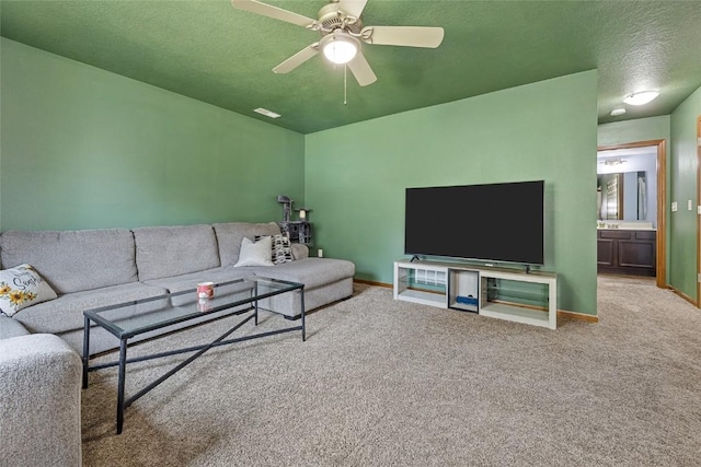 living room with ceiling fan, carpet, and a textured ceiling